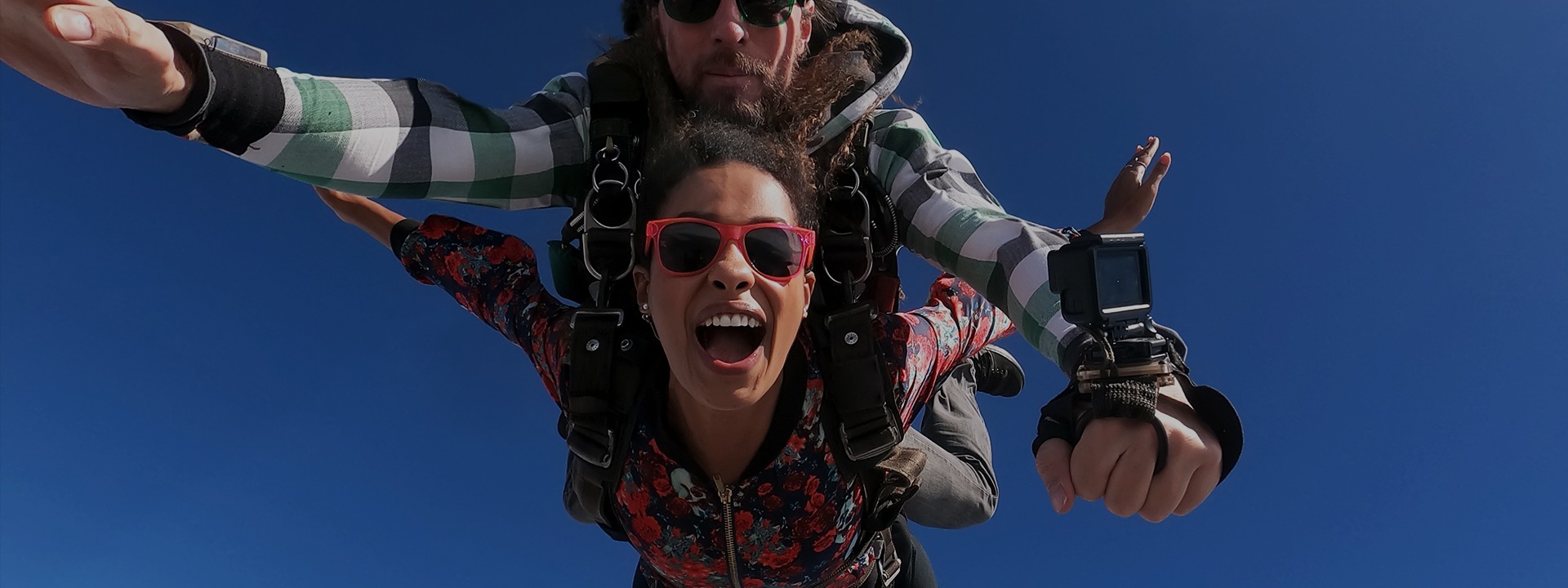 A man and a woman skydiving
