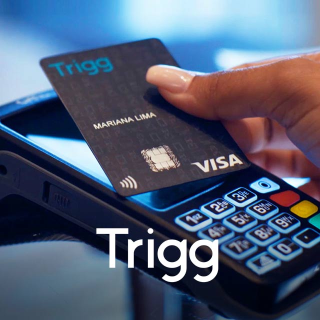 Close up of a person using a Visa card with a Trigg logo on it to make a point of sale transaction.