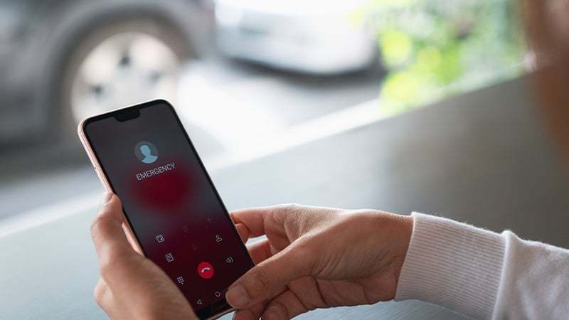 A person with a smartphone calling an emergency service